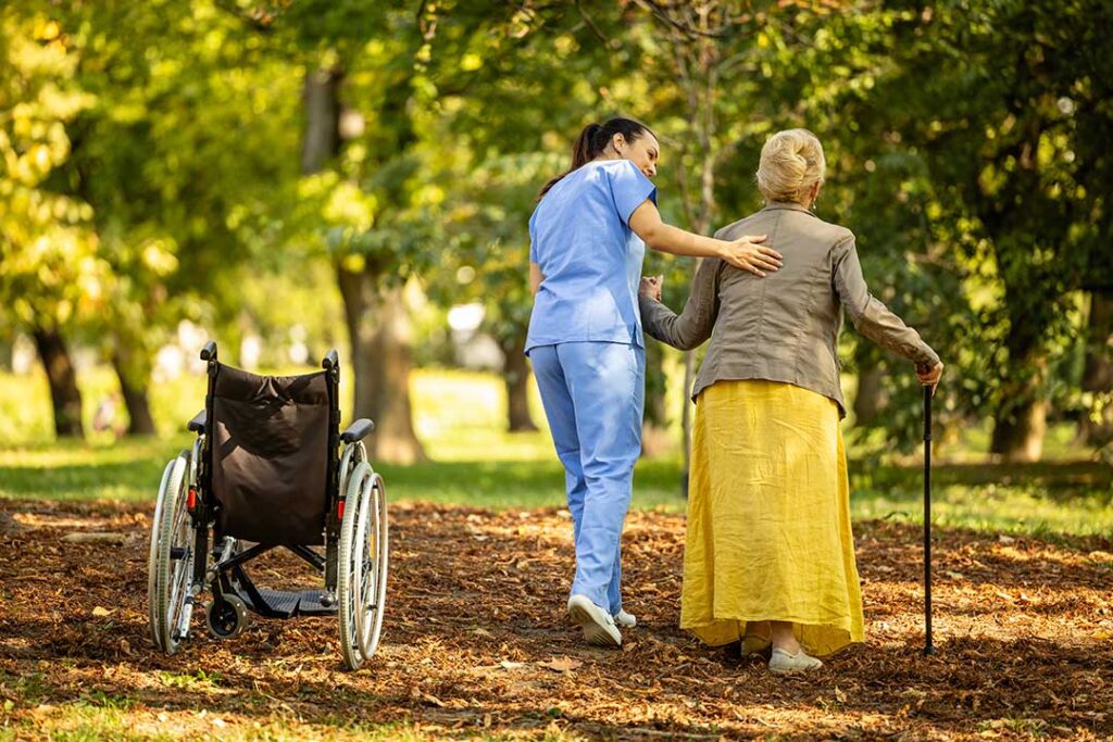 An older adult and family member review assisted living options at a kitchen table.