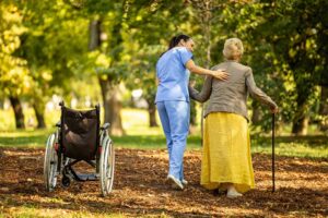 An older adult and family member review assisted living options at a kitchen table.